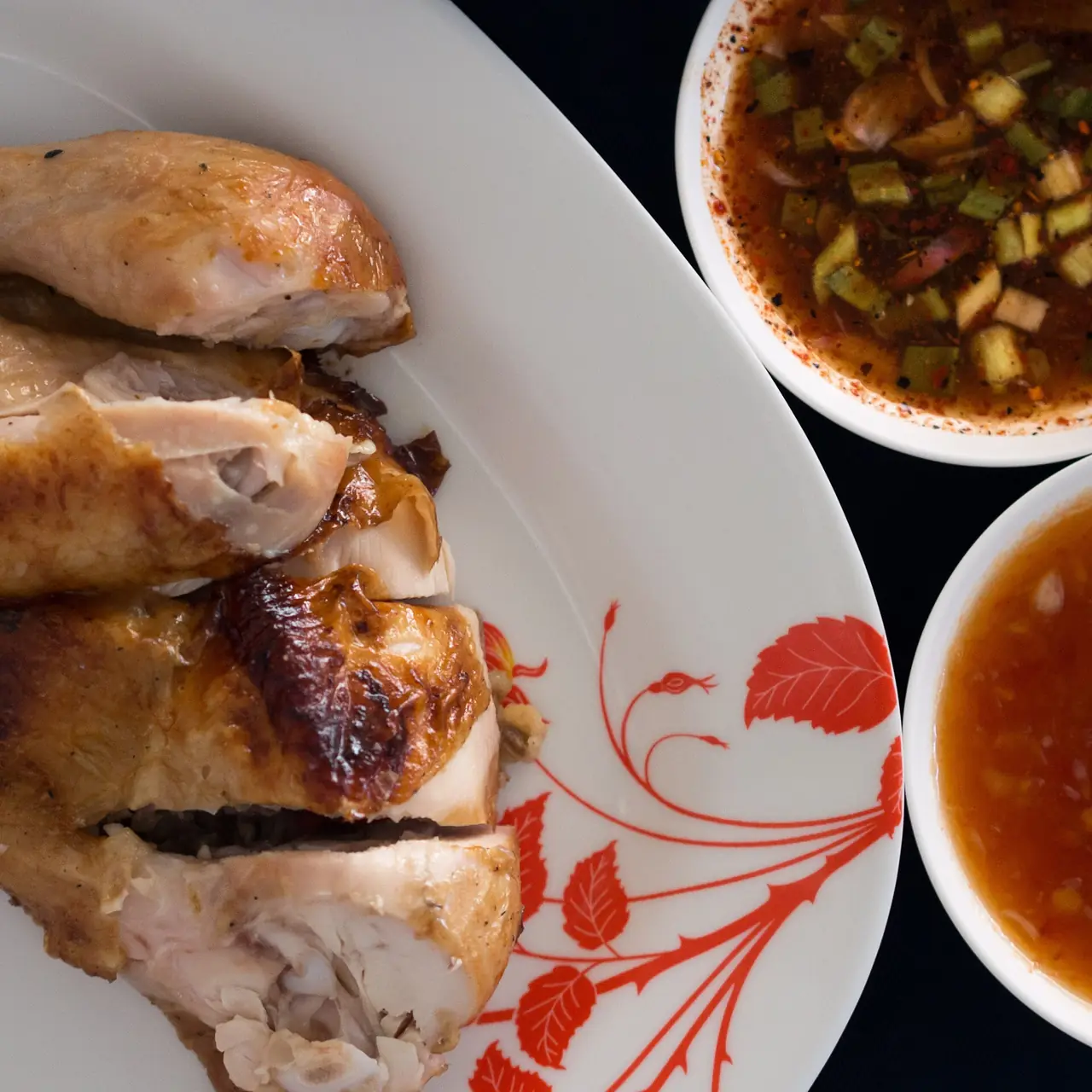 ไก่ย่างหั่นชิ้นกับน้ำจิ้มสองแบบ ภาพจาก Wikimedia Commons ผู้ถ่าย Takeaway สัญญา CC BY-SA 3.0 เป็นภาพประกอบ ไม่ใช่ร้านในอีสาน