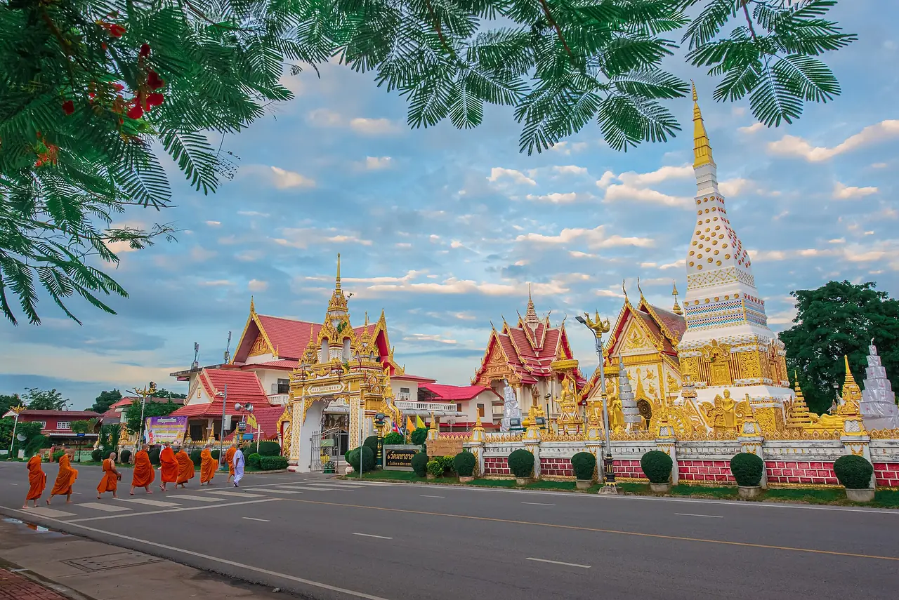ถนนหน้าวัดมหาธาตุ นครพนม พระสงฆ์เดินบิณฑบาตริมถนน และเจดีย์ประดับทองข้างหลัง ภาพจาก Wikimedia Commons ผู้ถ่าย JayaJoe สัญญา CC BY-SA 4.0 ตามชื่อไฟล์เป็นวัดมหาธาตุ นครพนม เป็นภาพประกอบหมวดพระธาตุนคร เรายังไม่พบภาพ Commons ของพระธาตุศรีคุณ พระธาตุมหาชัย และพระธาตุมรุกขนครที่ใช้ได้ตามเงื่อนไขของเรา