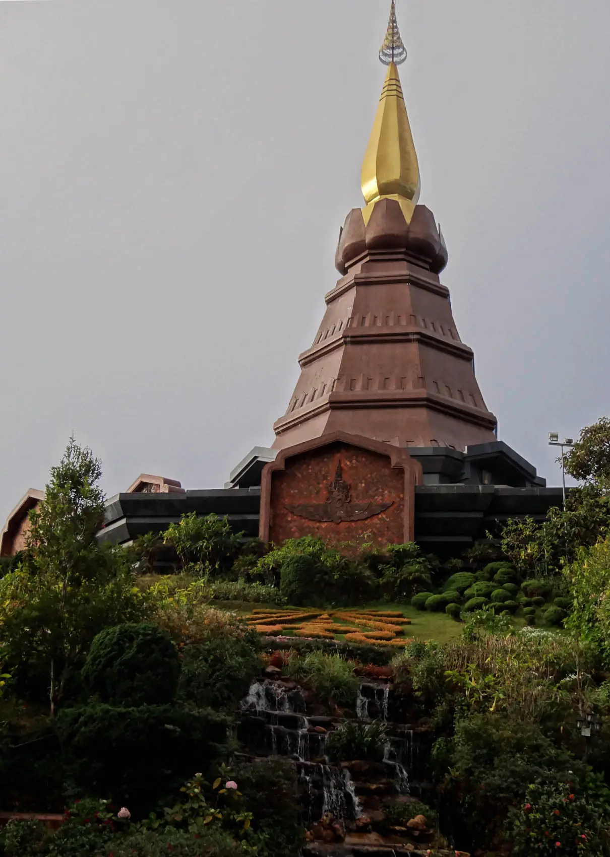 พระมหาธาตุนภเมทนีดล เจดีย์สีน้ำตาลอมแดงยอดทอง มีสวนน้ำตกจำลองอยู่ด้านล่าง ภาพจาก Wikimedia Commons ผู้ถ่าย Andrevruas สัญญา CC BY-SA 3.0 ชื่อไฟล์ระบุว่าเป็นองค์นภเมทนีดล ไม่ลงวันที่ถ่าย